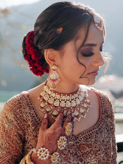 A destination wedding in the mountains calls for a touch of drama. I created a deep, smoky eye for this bride, contrasting beautifully with the soft light and her intricate lehenga for a truly royal feel.