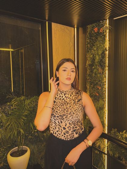 A confident pose in my leopard print top, perfect for a dinner or drinks.