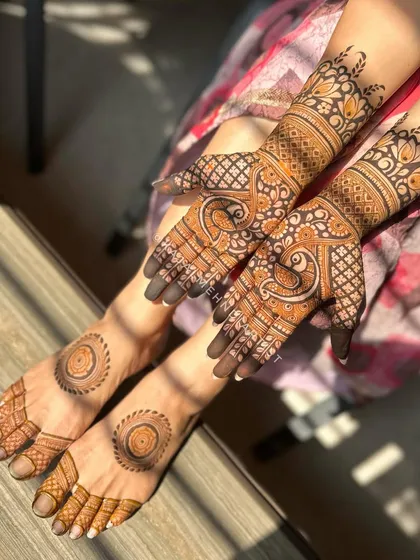 A complete look for an engagement, with detailed henna on the hands and simple matching mandalas on the feet.