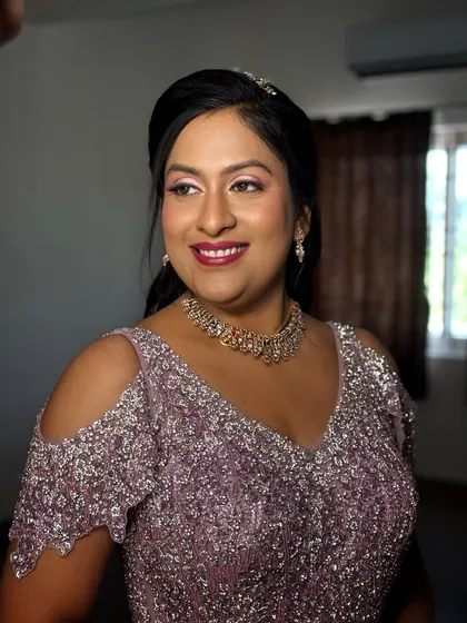 A happy, smiling portrait of this bride in her princess gown, her makeup looking glamorous and joyful.