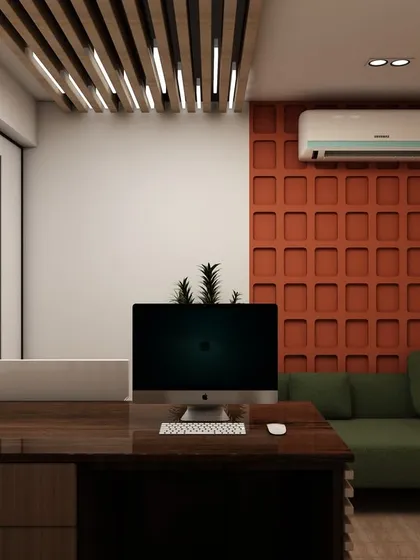 This private office design features a bold, textured accent wall in a burnt orange hue, adding personality and warmth. The space is balanced with a comfortable green sofa for guest seating or relaxation.