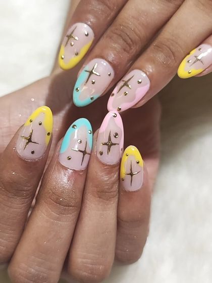 This angle highlights the almond shape and the placement of the star charms on the pastel set.