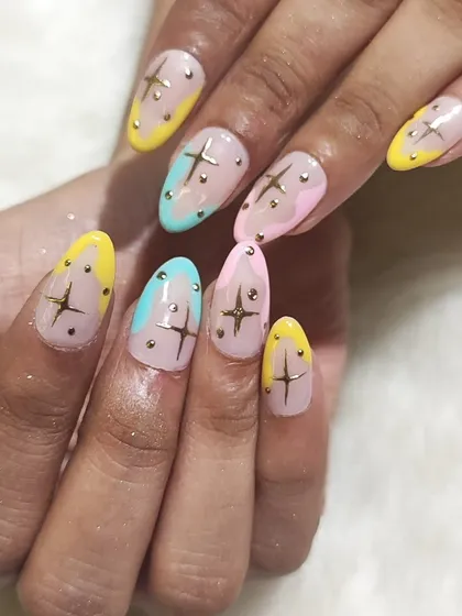 This angle highlights the almond shape and the placement of the star charms on the pastel set.