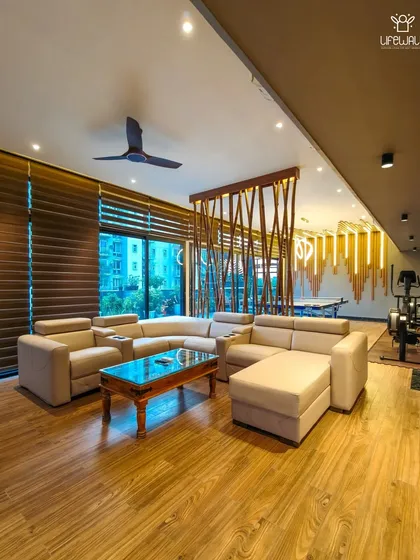 The lounge section of a spacious rooftop room. This shows how I can create multiple zones within one structure, including a comfortable L-shaped sofa for relaxation and a dedicated gaming area.