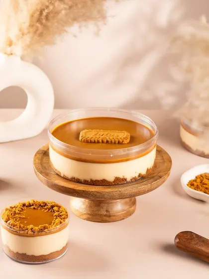 A beautiful Biscoff lotus cheesecake in a tub. This shot is perfect for delivery menus and takeaway brands.