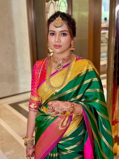 A detailed close-up of the makeup, showing the defined eyes and flawless skin that complement the traditional attire.