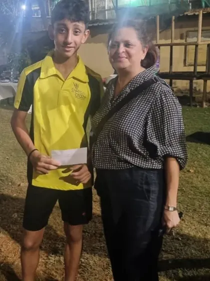 Zehn posing with a tournament organizer after his victory. We encourage our players to participate in a variety of competitive events.