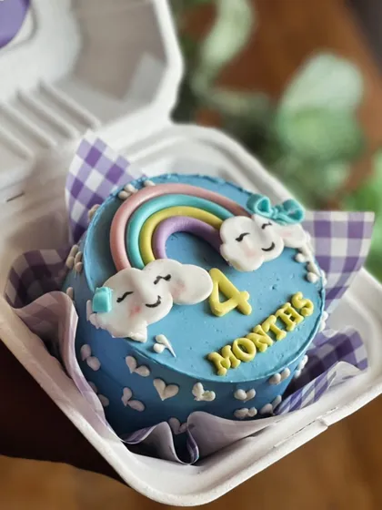 Our bento cakes are perfect for celebrating smaller milestones with big emotions. This custom four month celebration cake, with its cheerful rainbow and smiling clouds, shows how we pack a lot of love into a tiny, delicious treat.