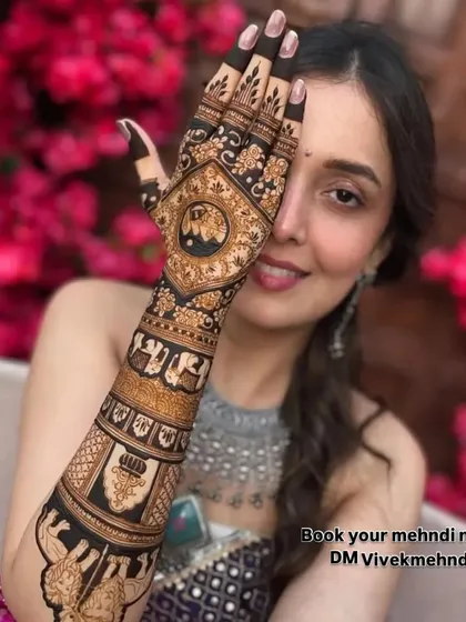 A happy bride is my biggest reward. Here, you can see the beautiful blend of traditional motifs like elephants and jharokhas with intricate patterns. This is a perfect example of a royal bridal mehndi design that looks stunning in photos.