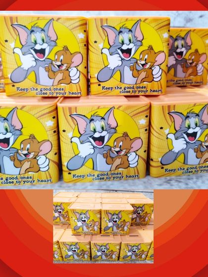 A batch of Tom and Jerry themed piggy banks, featuring the classic duo and the quote "Keep the good ones close to your heart."