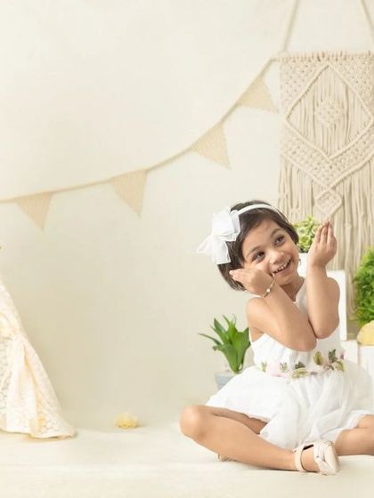 My boho-themed sessions use natural textures like macrame, wood, and greenery to create a calm and earthy setting that beautifully complements your child's simple joy.