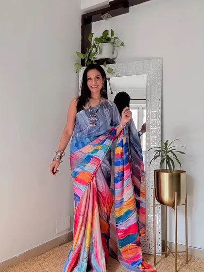 A vibrant, multi-colored abstract print saree that is sure to brighten up any workday. It's a bold, confident choice for the modern working woman.