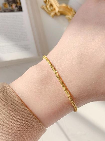 A delicate and shimmering bracelet worn on the wrist. This piece is perfect for adding a subtle sparkle to your everyday look.