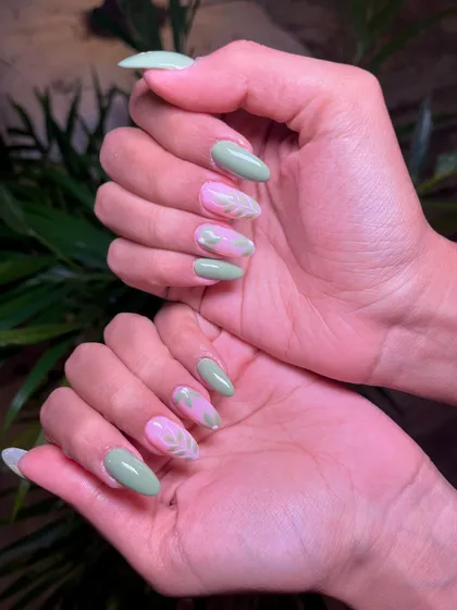 A full view of the pastel green and pink leaf-themed manicure, perfect for a fresh, springtime look.
