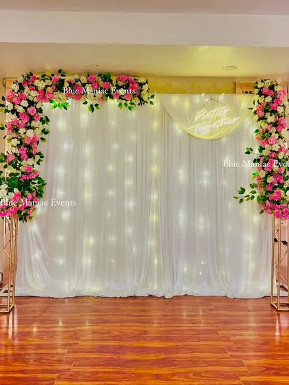 The same Roka backdrop without the seating, highlighting the clean lines of the floral frame and the sparkling fairy light curtain. This shows the versatility of the backdrop for different needs.