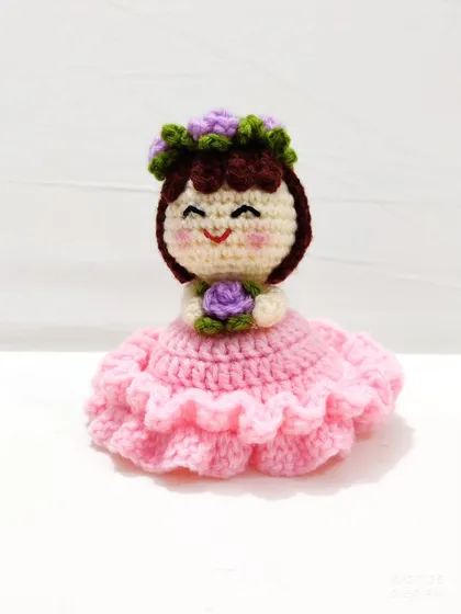 This reversible bouquet doll is two gifts in one. It starts as a beautiful floral bouquet and flips inside out to reveal an adorable doll in a pink frilly dress with a flower crown.