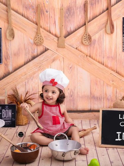 A happy little chef, ready to mix and stir in our wonderfully detailed and safe studio kitchen set.