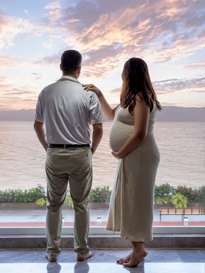 Sometimes the most beautiful backdrop is your own home. This cozy, at-home maternity session was shot against their window, using the natural sunset to create a warm, personal, and intimate portrait.