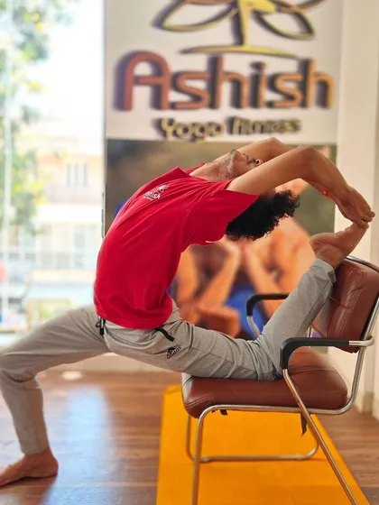 A demonstration of an advanced backbend using a chair, showing how props can help even the most experienced yogis explore new depths.