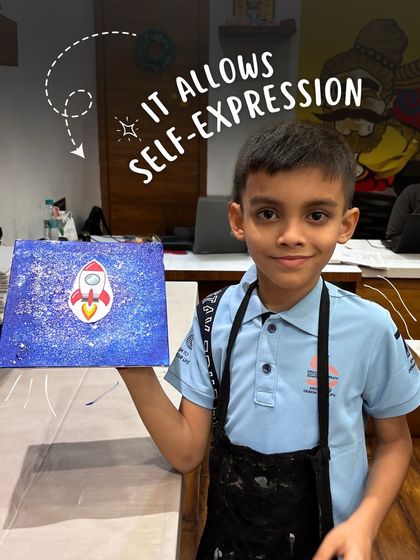 This young man proudly displays his finished canvas painting of a rocket ship soaring through a galaxy. My classes encourage self-expression and allow kids to paint their dreams.