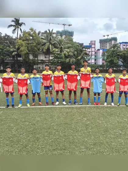 Another shot of our alumni holding up their new club jerseys, showcasing the pathway we provide for young talent.
