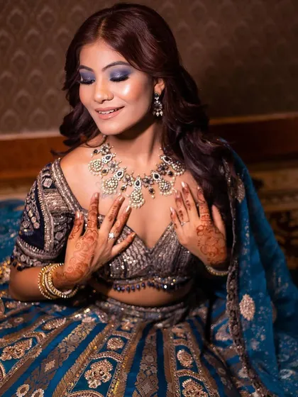 The full look, with the intricate blue lehenga and diamond jewelry, is pure glamour and perfect for a reception.