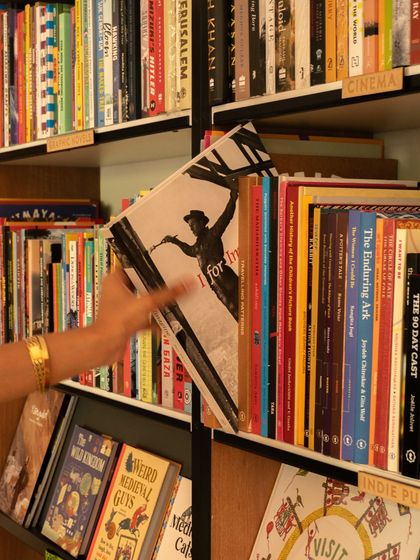 A customer browsing the indie publications section at our Champaca Bookstore corner. I love seeing people discover new authors and stories on our shelves.