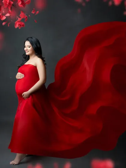 A powerful pose in a stunning red gown. The fabric appears to fly, creating a sense of strength and grace that perfectly embodies the spirit of motherhood.