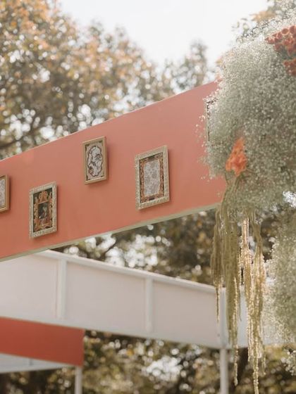 A detail of the canopy, adorned with personal framed photos, adding a unique and sentimental touch to the wedding decor.