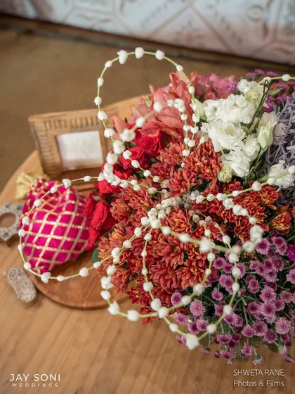 An overhead shot of a floral arrangement, showing the beautiful textures and the delicate strings of jasmine woven through it.