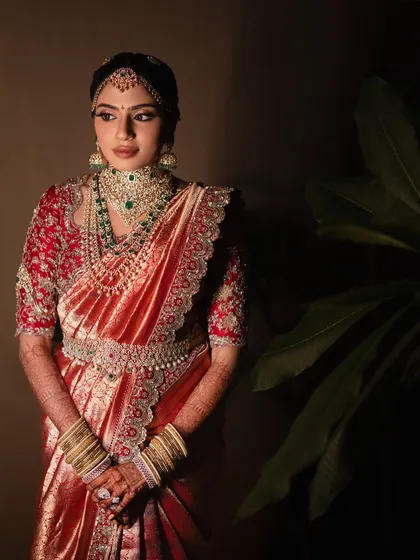 A beautiful client looking radiant in a traditional red and gold silk saree. This is a perfect example of timeless bridal elegance, and it is an honour to be a part of such moments.