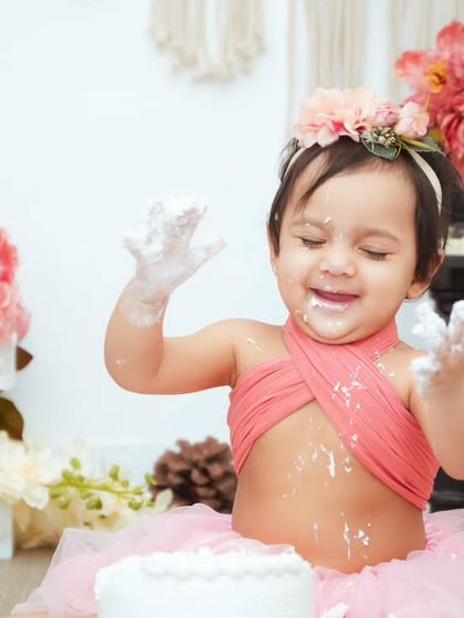 A moment of pure delight! Her eyes are closed in happiness as she enjoys her first birthday cake.