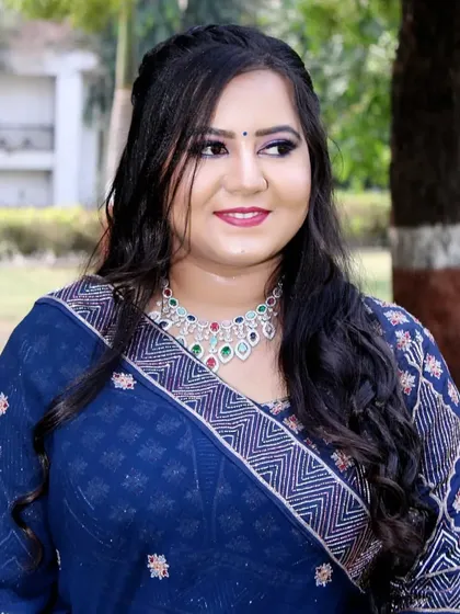 A happy client in the park during her engagement photoshoot. The makeup is designed to look fresh and vibrant even in natural light.