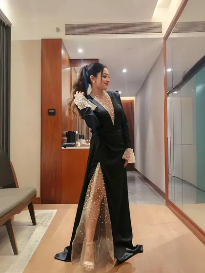 A full view of my black and pearl gown. The sheer, embellished leg panel added a modern and daring touch to the classic black dress.
