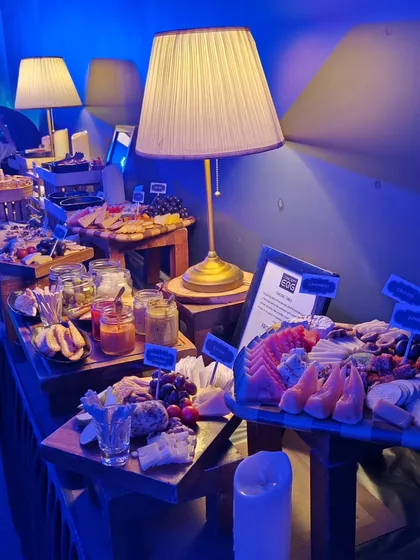 A wide shot of the extensive grazing buffet at the Mercedes EQ launch. The setup features multiple levels and a variety of boards, creating an impressive landscape of food for guests to explore.
