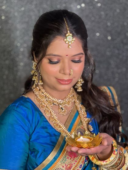 A layered antique gold necklace set paired with a beautiful blue saree. This look is perfect for guests or for the bride at a smaller function.