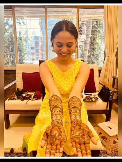 The beautiful bride-to-be, so happy with her personalized engagement mehendi. Her smile says it all!