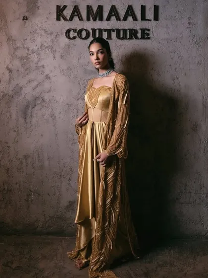 The full look of the golden corset gown and embellished jacket, where classic craftsmanship meets contemporary allure.