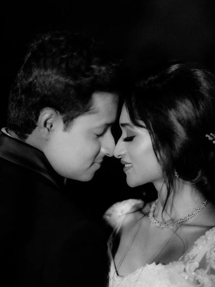 A close-up black and white shot capturing an intimate, quiet moment. The monochrome tones enhance the emotion and tenderness between the couple.