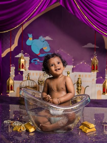 Looking up with a happy smile, this little one is enjoying his magical bath in Agrabah.