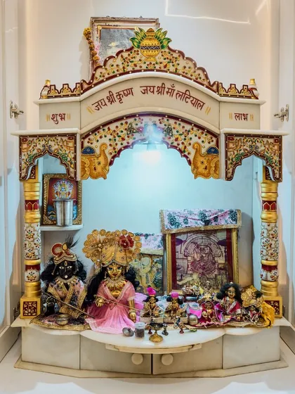 A grand and ornate marble mandir. This custom-built pooja room is designed for a client who wanted a dedicated and traditional space for their deities.