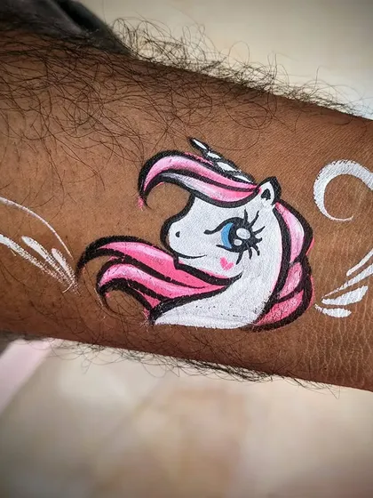 A simple and cute unicorn head painted on the wrist.
