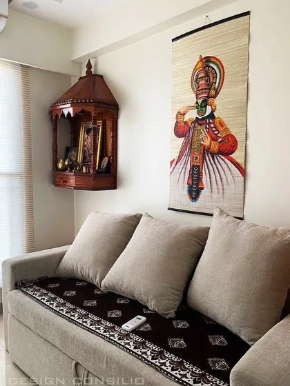 A simple yet beautiful pooja corner. We installed a ready-made wooden temple and paired it with traditional Indian artwork to create a dedicated spiritual space in the living room.