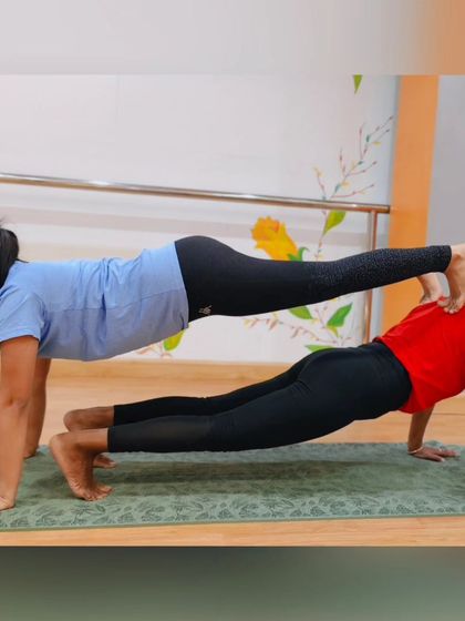The double plank, a classic partner yoga pose that seriously challenges your core strength and stability. It's all about finding that perfect point of balance together.