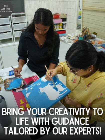 An instructor assists a student with her Pichwai-style painting, showcasing the hands-on guidance provided in every class.