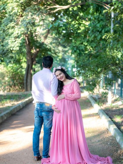 A sweet and candid moment between a couple on a park path.