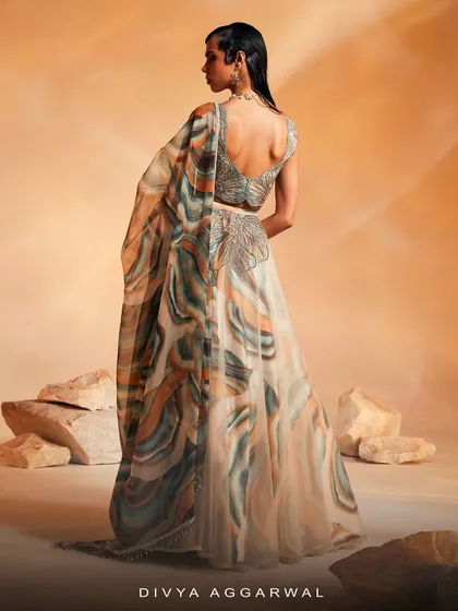 The back view of the Ivy Lehenga Set, showcasing the deep-back blouse design and the flowing, printed organza dupatta with embroidered borders.
