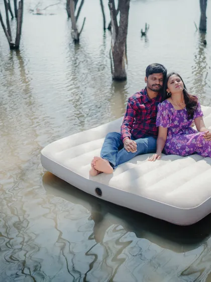 A candid moment of relaxation and affection during the unique lake mattress shoot. It shows the couple's comfortable love.