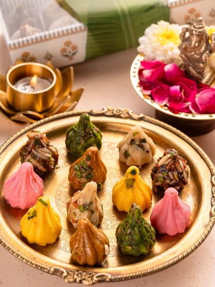 A platter of my assorted modaks is a beautiful sight during Ganesh Chaturthi. I offer a variety of flavors, including rose, pistachio, and chocolate, to make your prasad truly special.