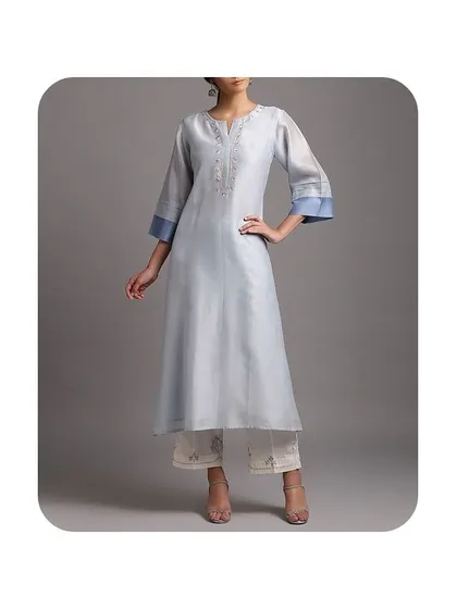 This light blue A-line kurti is made from a silk-blend fabric, giving it a subtle sheen. The bell sleeves with a contrasting cuff add a touch of elegance, making it suitable for semi-formal occasions.